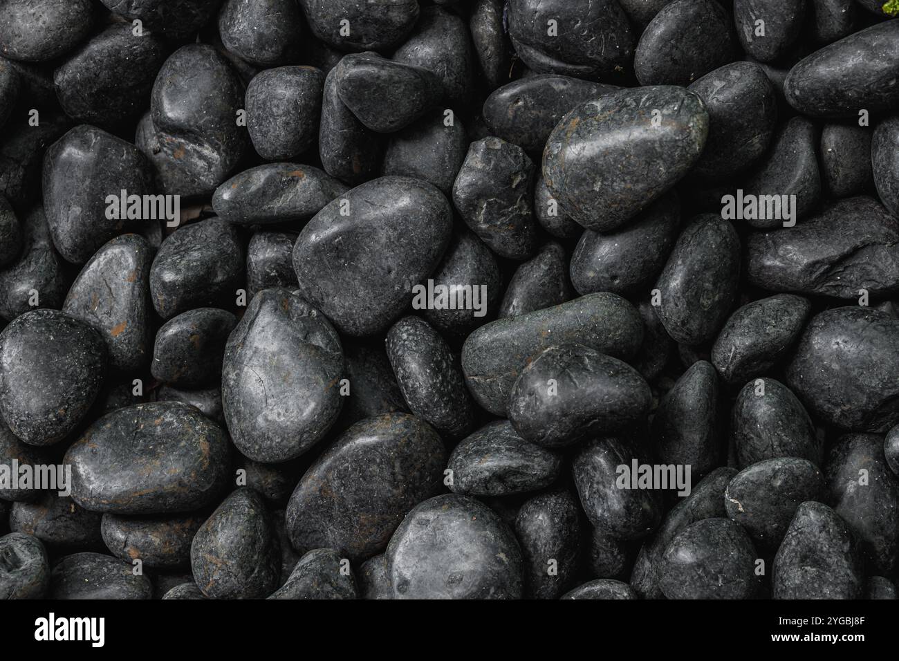 Black round curved river rocks pebbles stone for nature pattern texture ...
