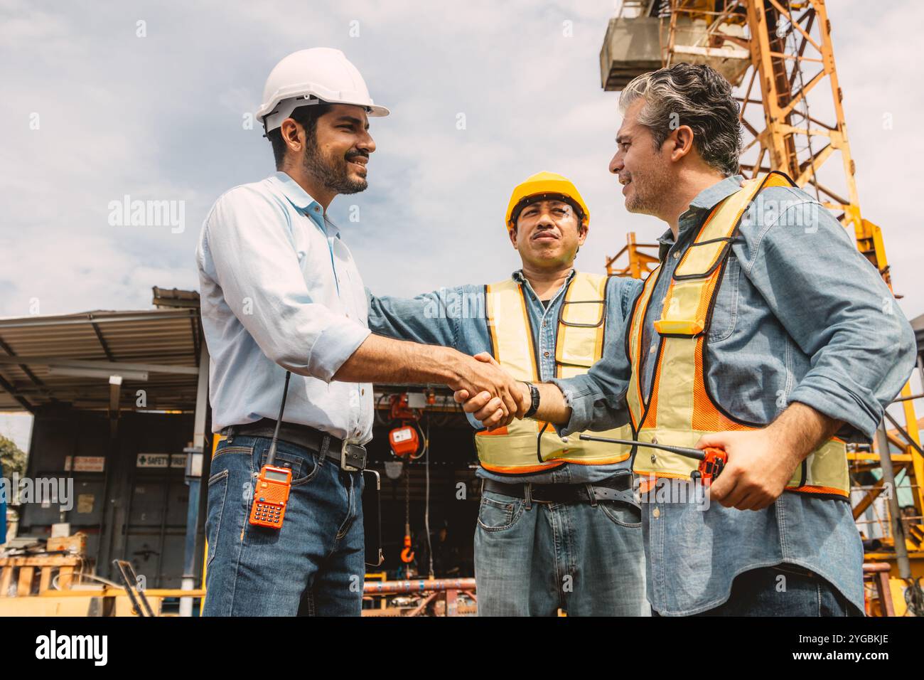 Workers team hand shaking deal with contractor happy at construction site. Engineer project business contact connection people concept. Stock Photo