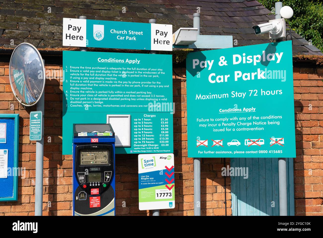 A pay station at Church Street pay and display car park with parking charges, a cctv camera & ring go app sign. Stratford upon Avon, England Stock Photo