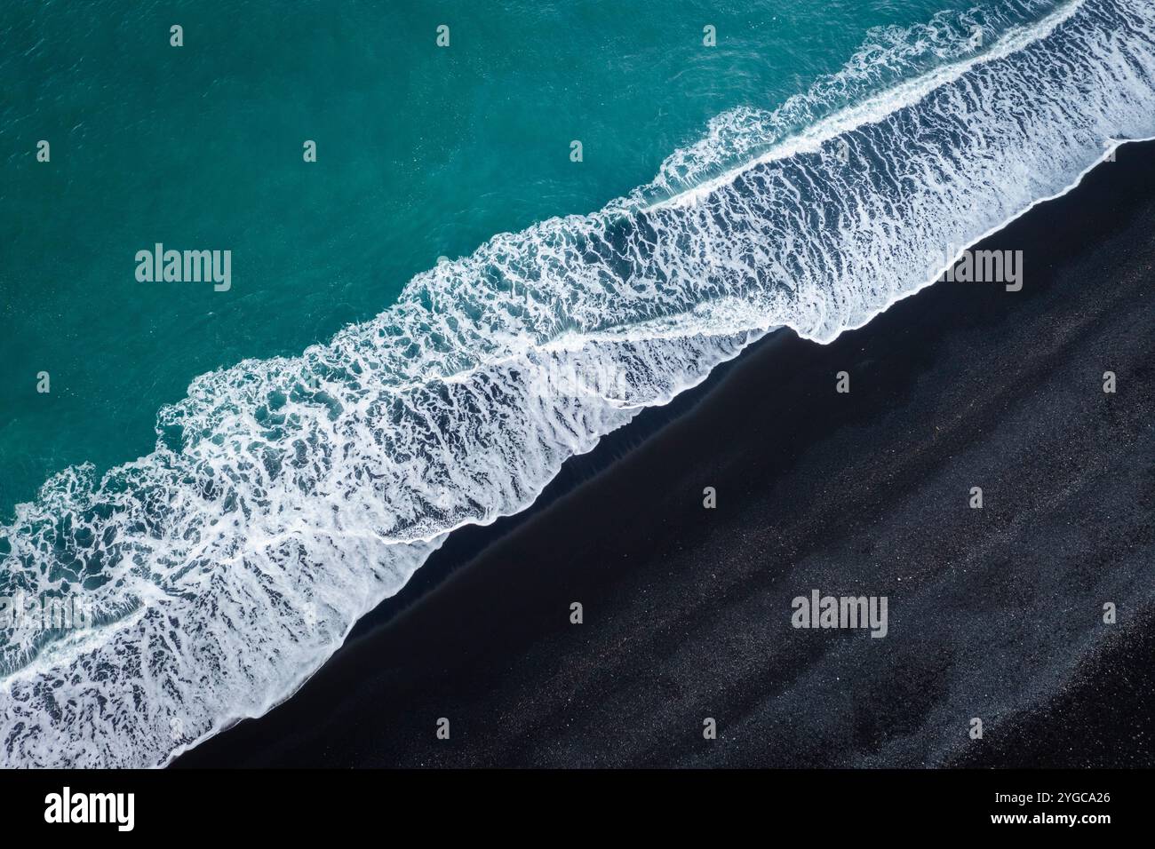Aerial view of waves on the black sands of Reynisfjara beach. Vík í Mýrdal, Southern Iceland, Iceland, Northern Europe. Stock Photo
