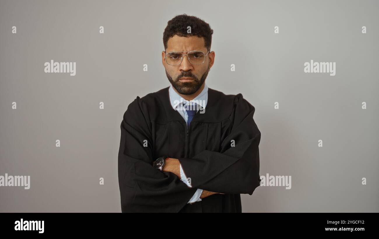 Serious man in judge's robe with crossed arms and glasses standing ...