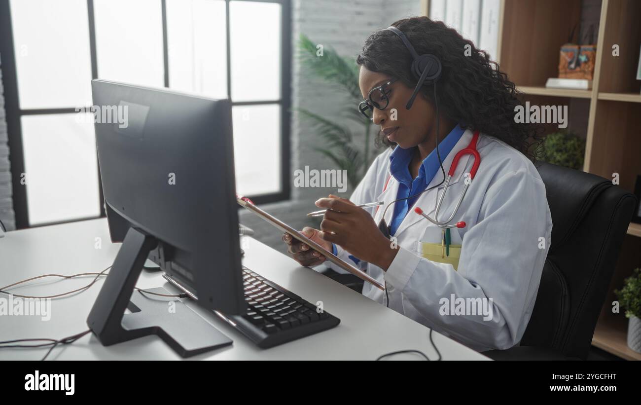 African american woman doctor taking notes in a clinic office setting ...
