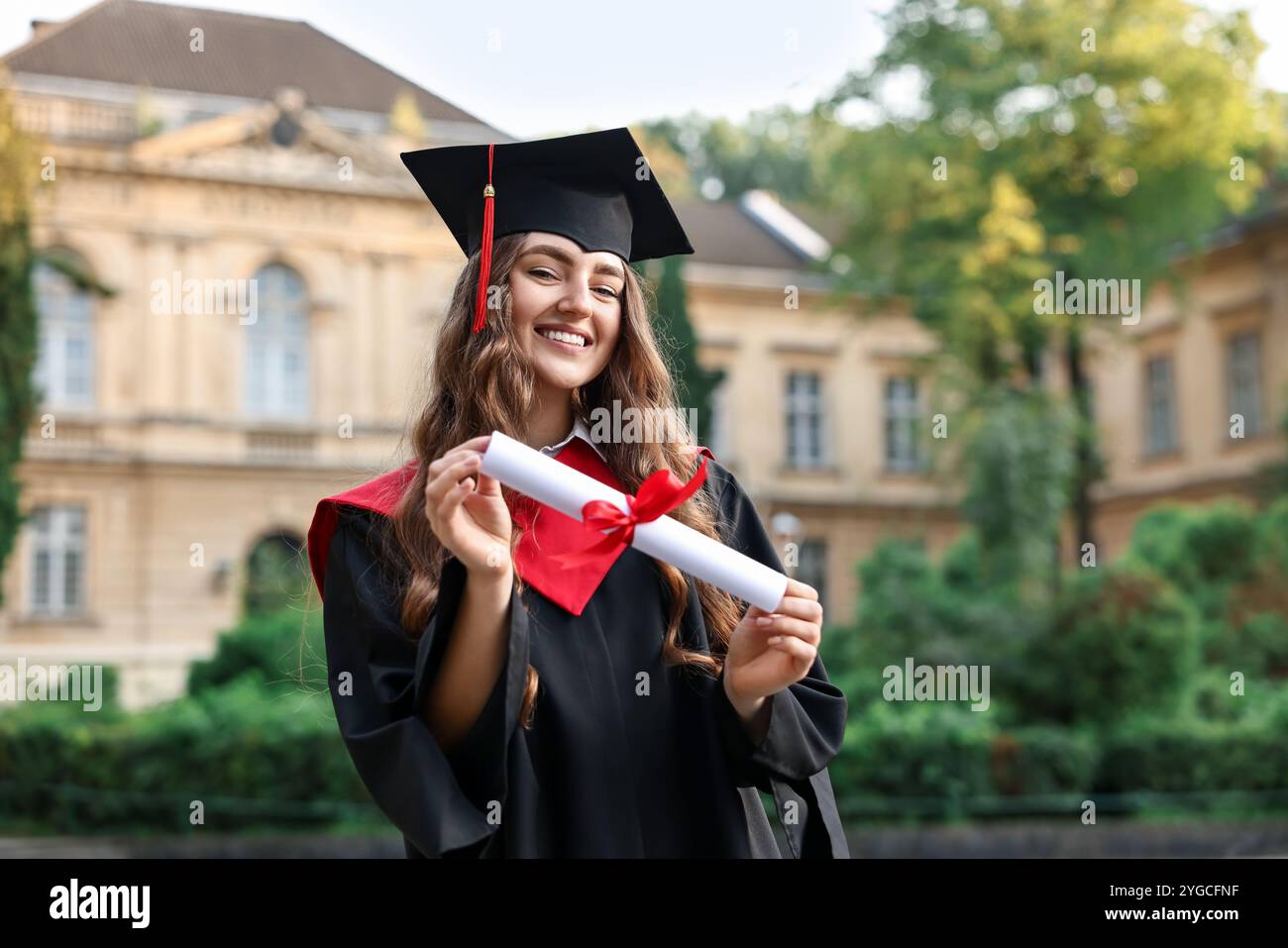 Happy student with diploma after graduation ceremony outdoors Stock ...