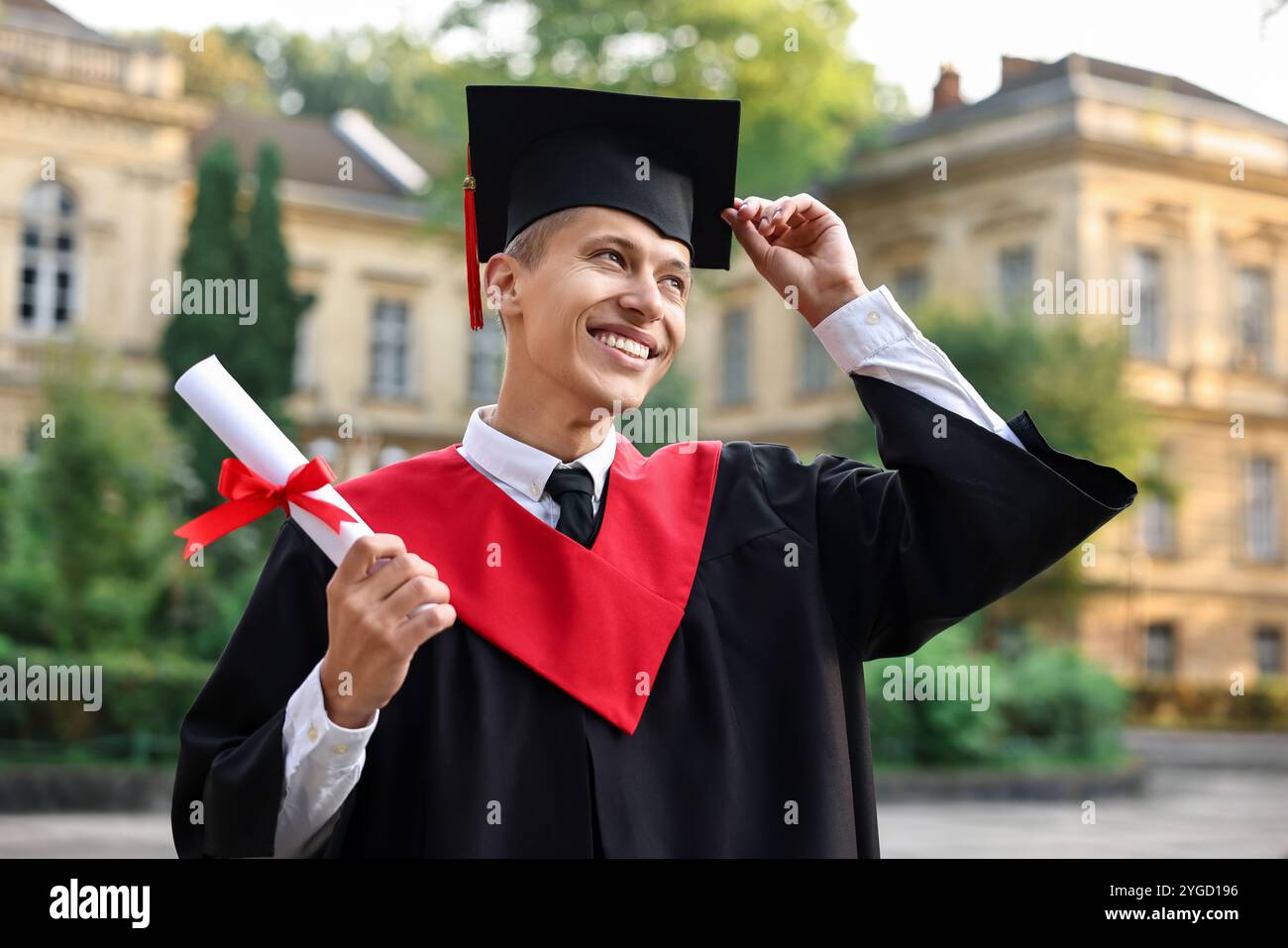 Happy student with diploma after graduation ceremony outdoors Stock ...