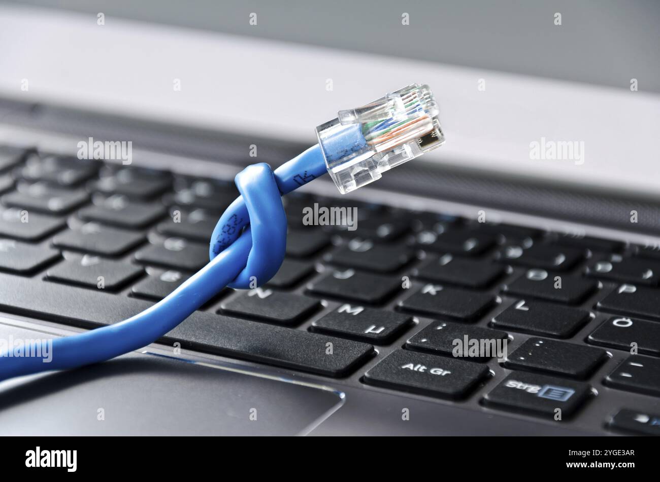 Internet cable with knot on a computer keyboard Stock Photo
