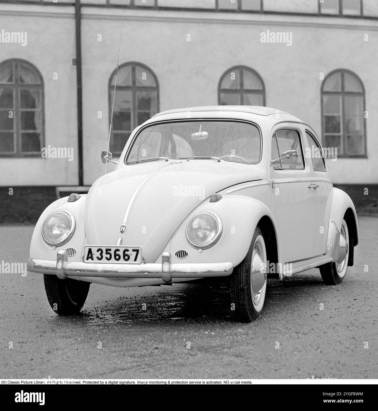 The Volkswagen Beetle, officially the Volkswagen Type 1,[a] is a small car produced by the German company Volkswagen from 1938 to 2003. One of the most iconic cars in automotive history, the Beetle is noted for its distinctive shape. Its production period of 65 years is the longest of any single generation of automobile, and its total production of over 21.5 million is the most of any car of a single platform. 1962 Stock Photo