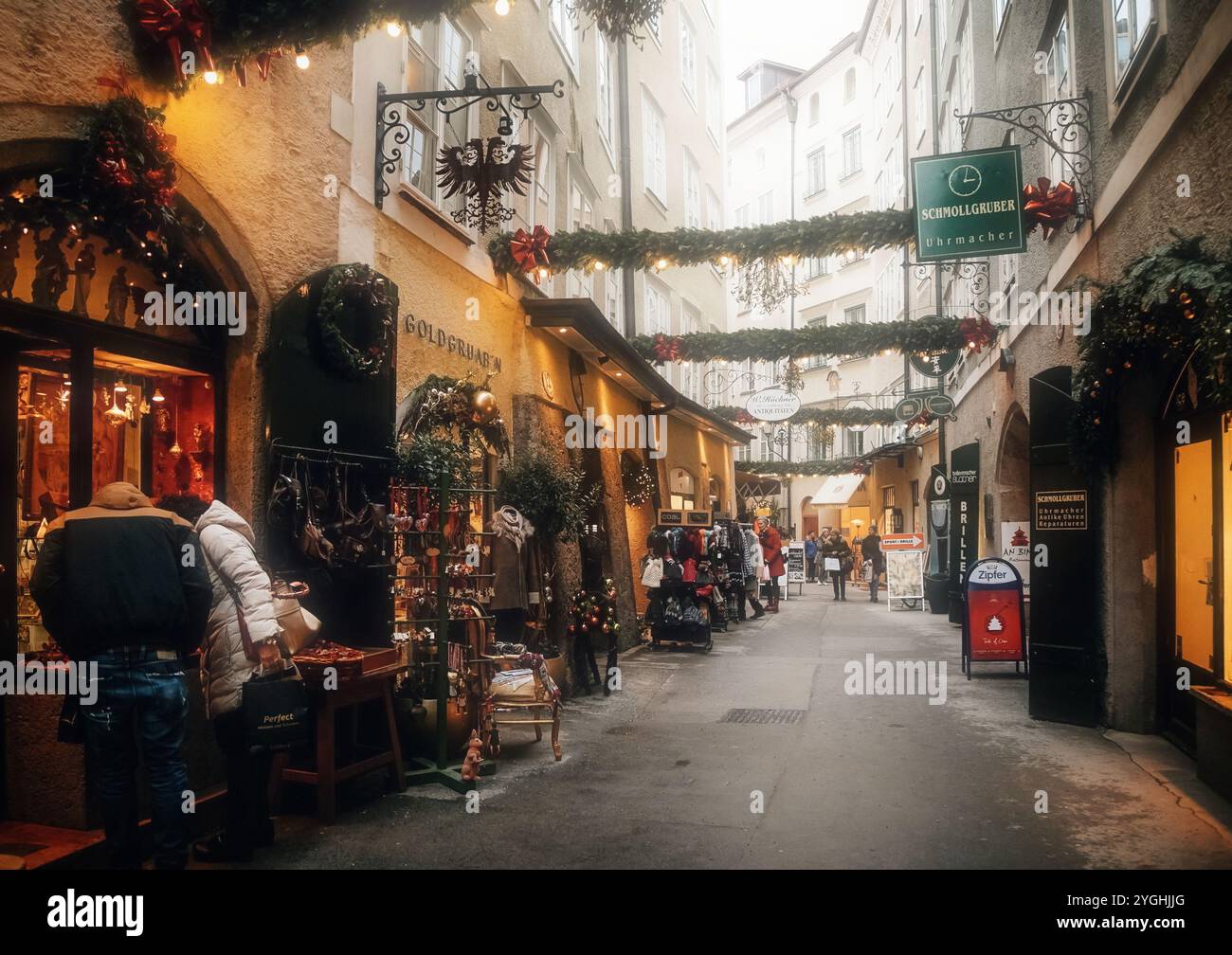 Austria, Salzburg, 12.01.2023 Holiday decoration at Goldgasse or Golden Street, old town, traditional advent, green Christmas tree branches outdoors i Stock Photo