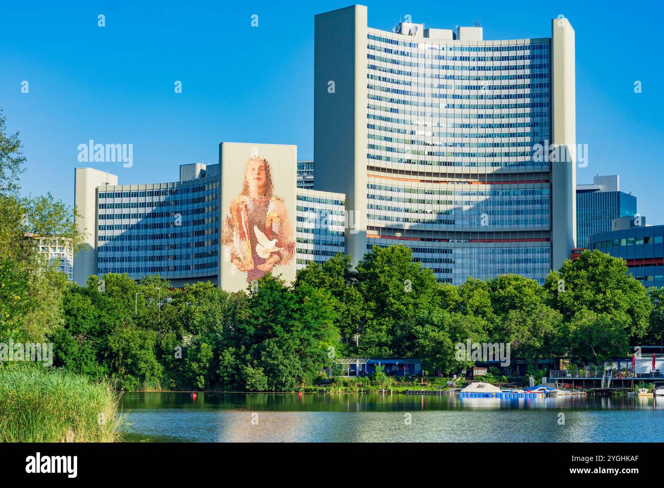 Vienna, Vienna International Centre (VIC, United Nations Office, UNO City), lake Kaiserwasser, huge graffiti painted on the wall of a tower by Australian street artist Fintan Magee. The mural is primarily intended to be a symbol of the UN Sustainable Development Goals. in 22. Donaustadt, Austria Stock Photo