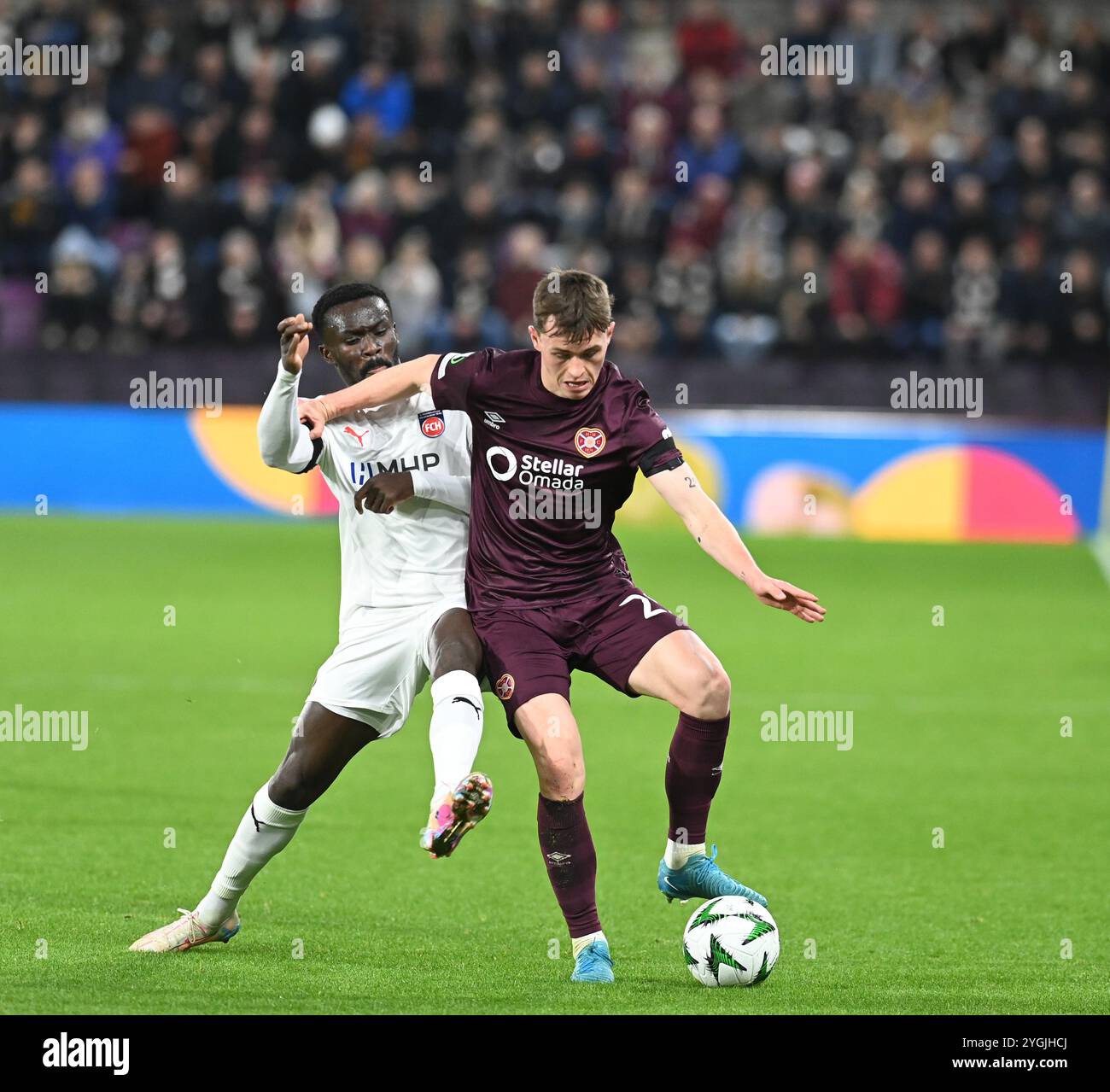 Tynecastle Park Edinburgh Scotland UK 7th Nov 24 UEFA Conference League match Hearts Vs Heidenheim  James Penrice of Hearts with  Sirlord Contehof FC Heidenheim Stock Photo