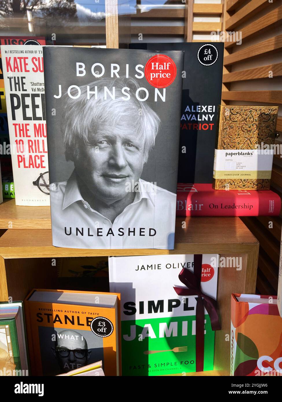Boris Johnson's memoir Unleashed in a book shop window at Half Price only three weeks after the publication date of 10th October 2024 - Smartphone Captured Stock Image