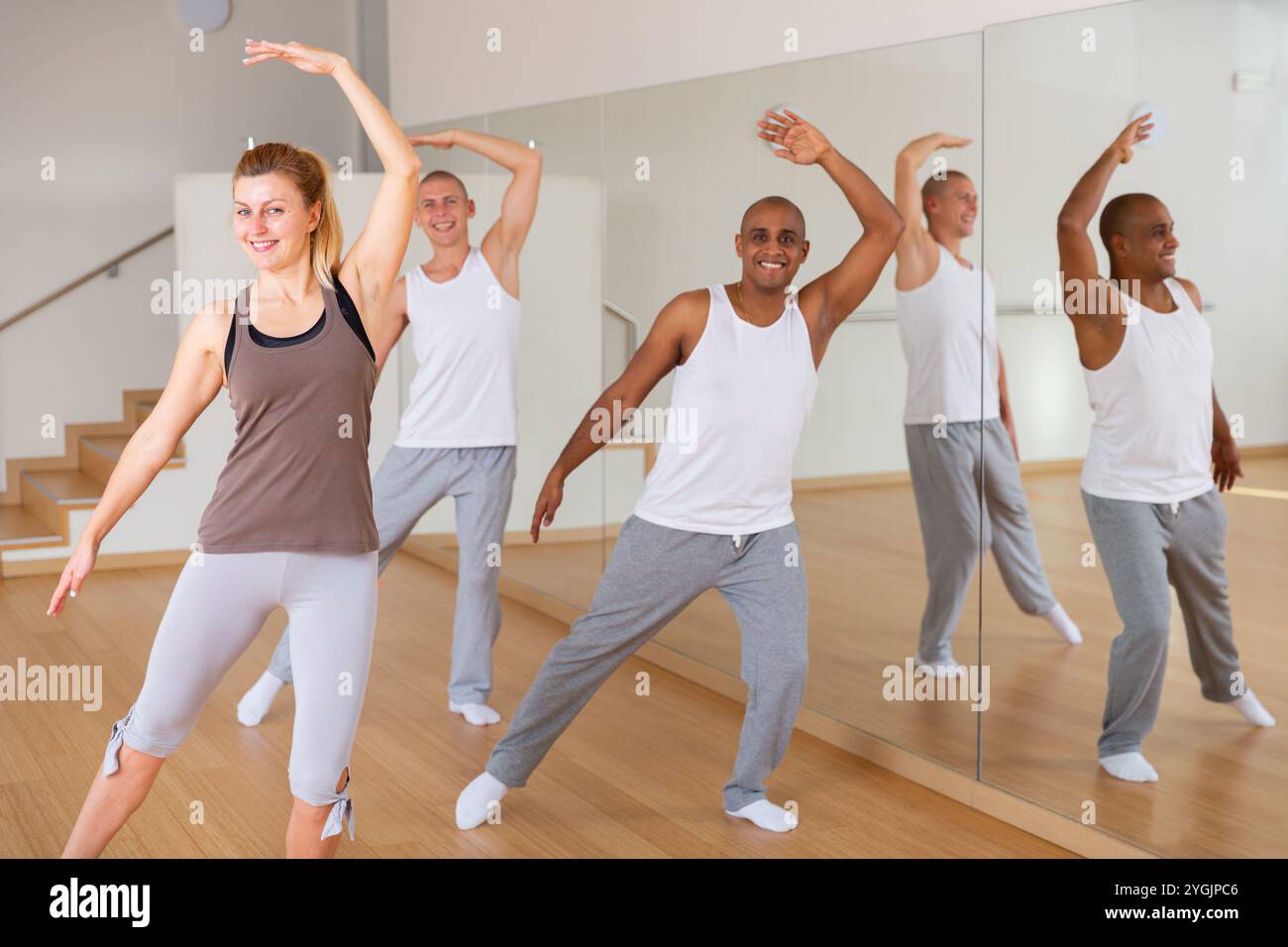 Young adults practicing dance movements in choreography class Stock Photo
