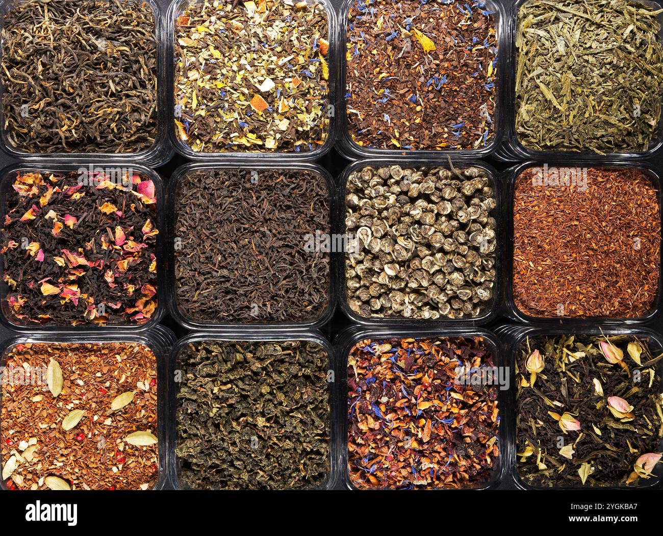 A vibrant assortment of loose-leaf teas in glass jars, featuring green ...