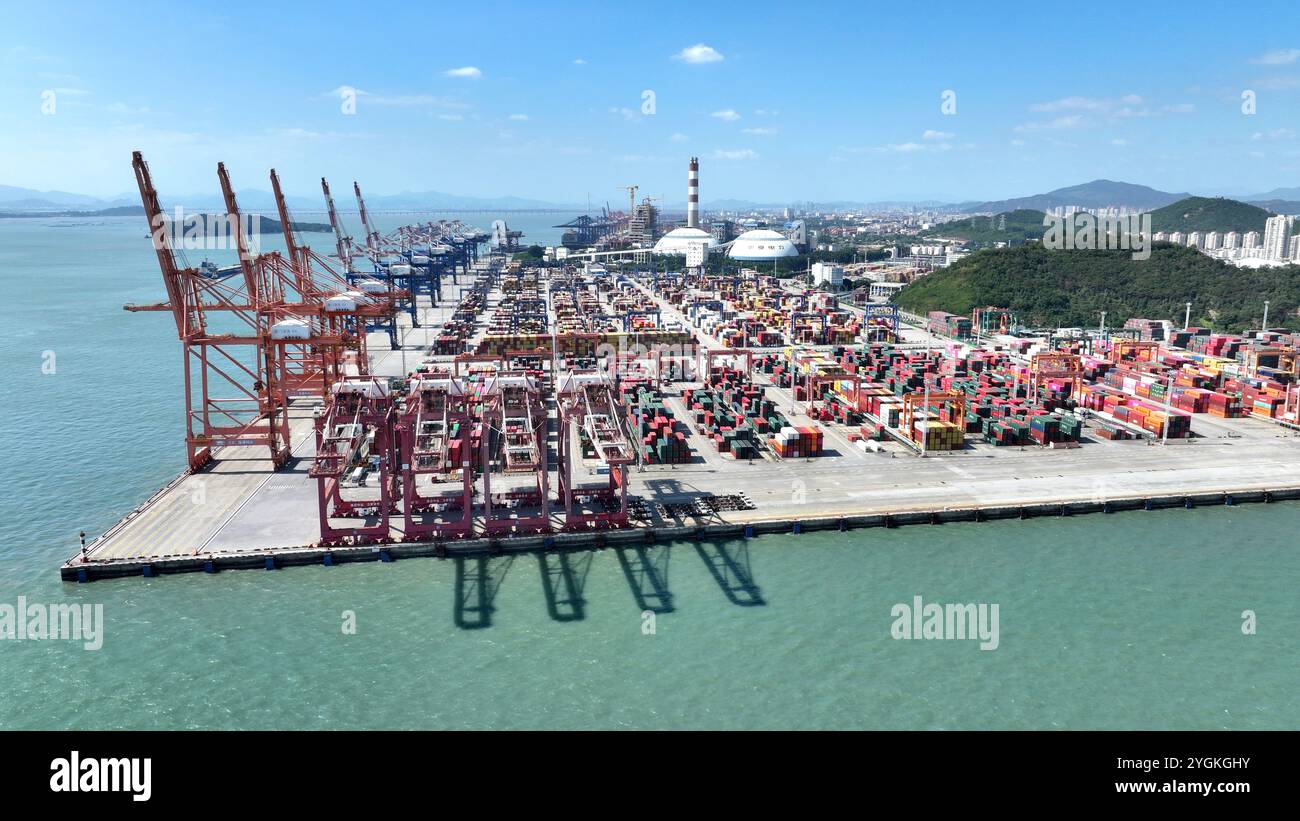 XIAMEN, CHINA - NOVEMBER 7, 2024 - Cargo ships load and unload at their ...
