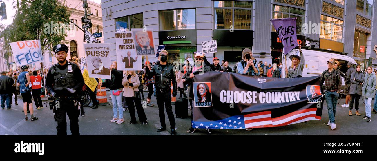 Choose Country Banner with Kamala Harris and Tim Walz held by Anti-Trump Protesters outside Madison Square Garden in NYC USA 27 Oct 2024 Stock Photo