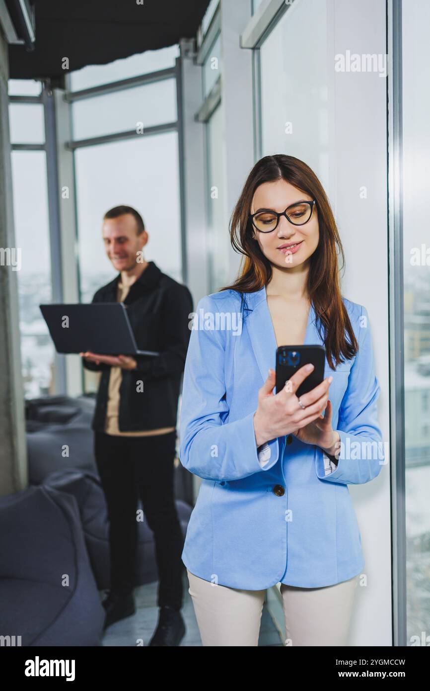 Two business people working remotely online using a laptop. Colleagues work remotely in the workspace. Stock Photo