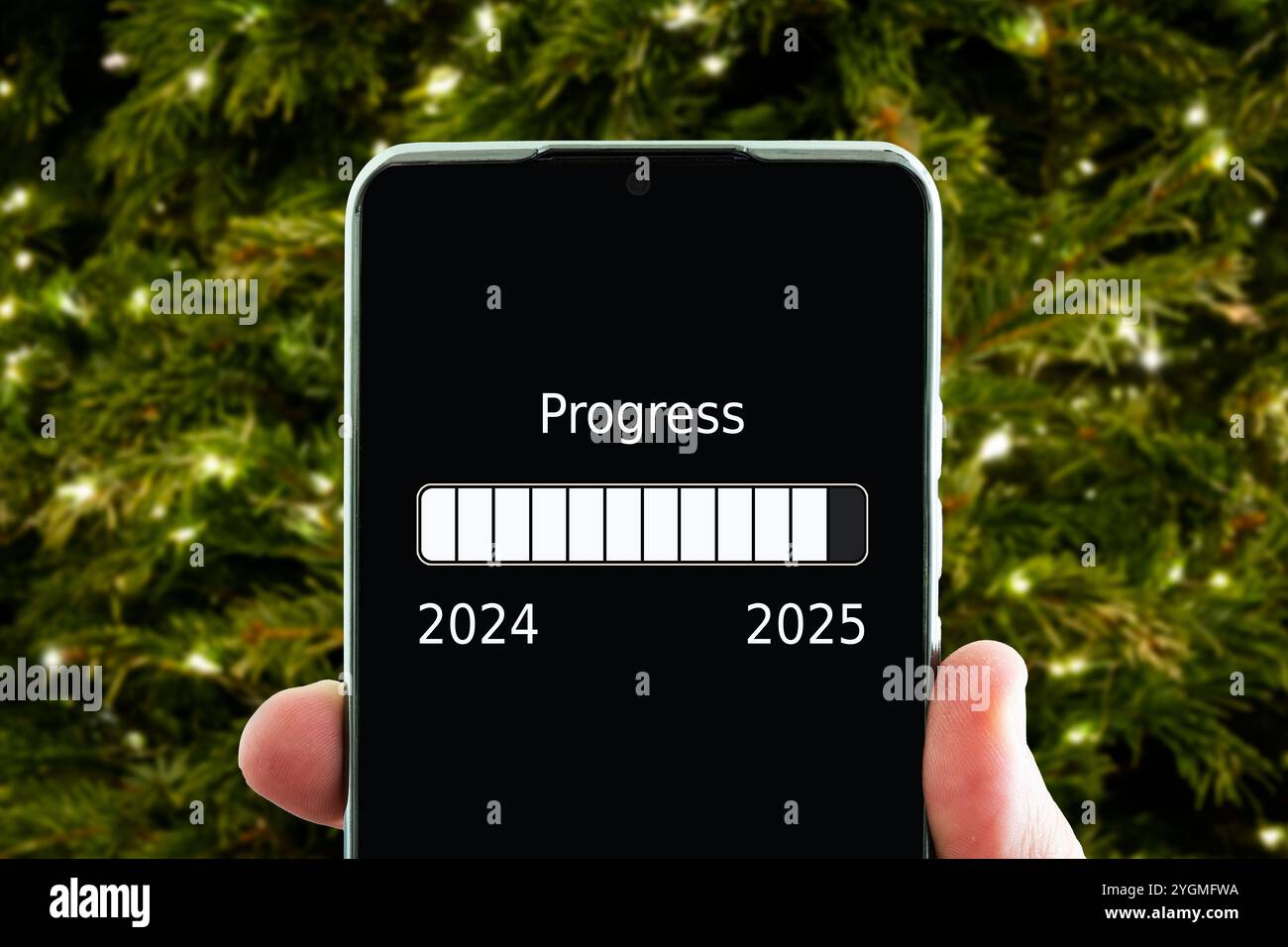 the concept of changing the year from 2024 to 2025. smartphone on the computer keyboard with the process of loading the new year. end of 2023 Stock Photo