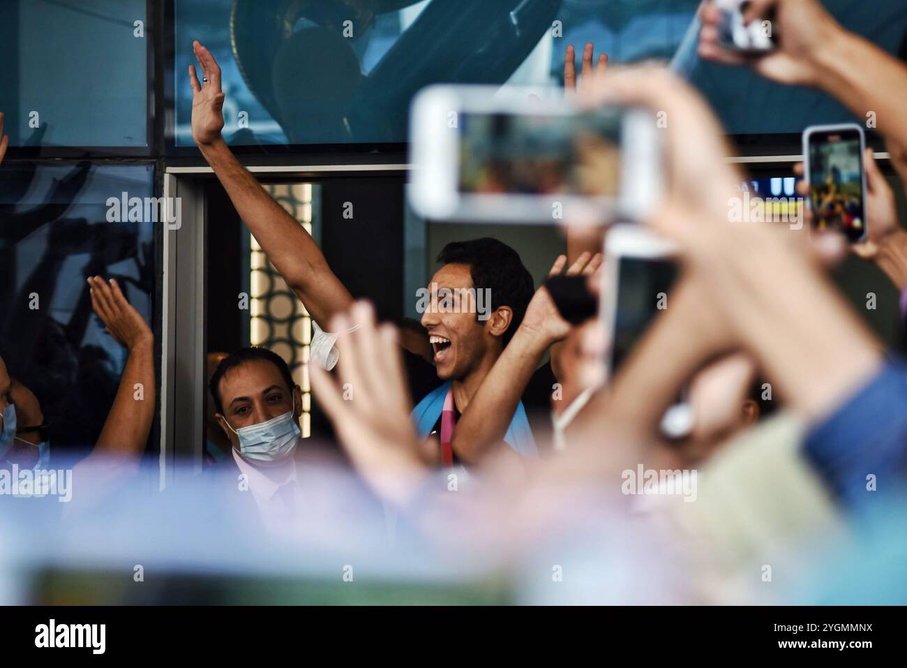 Cairo, Egypt. 28 July 2021. Egyptian athletes Hedaya Malak and Saif Issa receive a warm welcome as they arrive at Cairo Airport after winning the bronze medal at the 2020 Tokyo Olympics. Hedaya Malak and Seif Issa are players of taekwondo who won the bronze medal in the 67 and 80 Kg weight category respectively at the Olympic Games in Tokyo. Hedaya Malak won the medal in the women’s singles competitions after defeating the American Peggy McPherson 17/6, while Saif Issa won the medal in the men’s singles competitions after defeating Norway’s Ardoman 12/4. Stock Photo