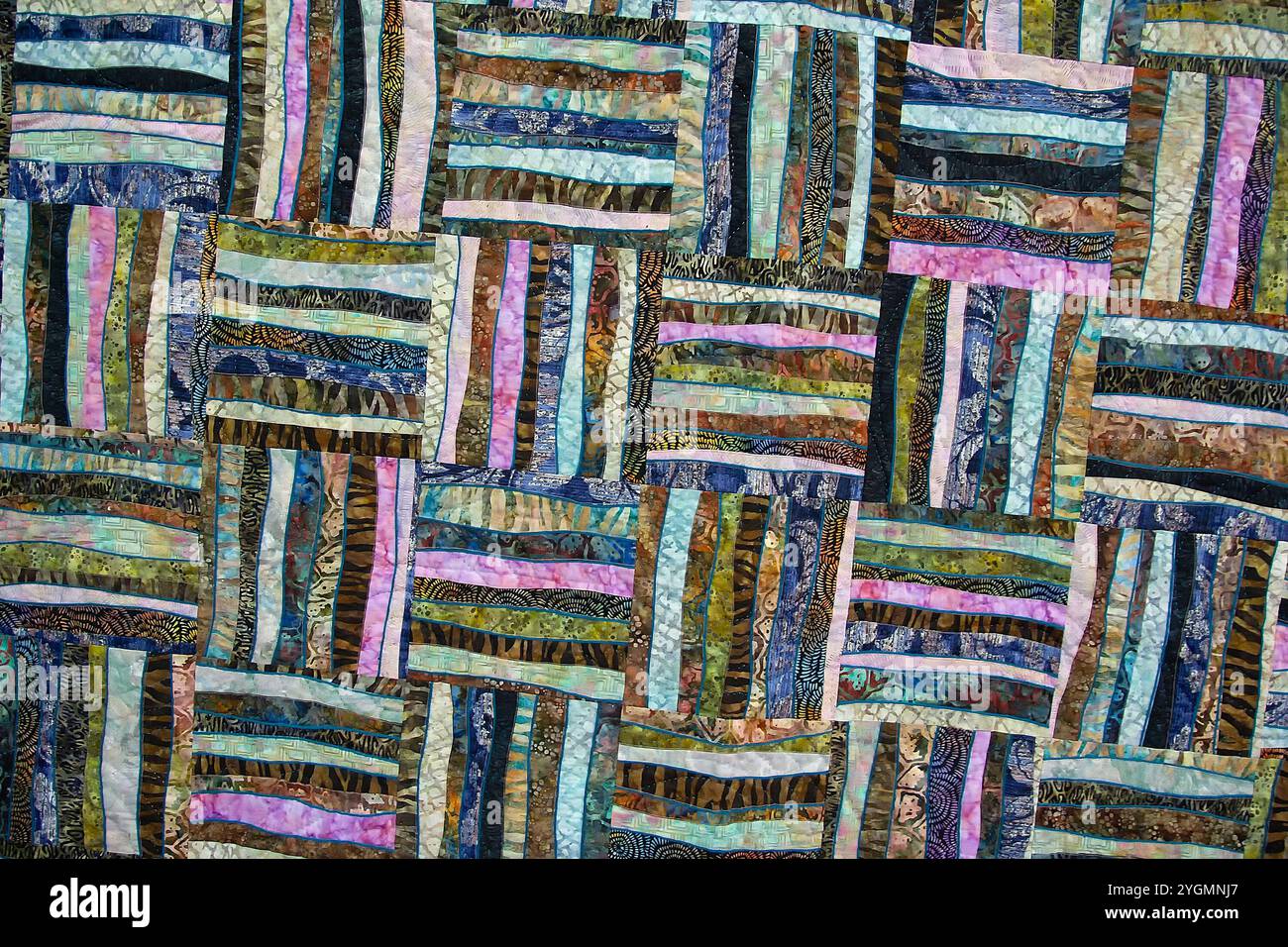 A patchwork quilt with many different colored squares. Abstract background Stock Photo