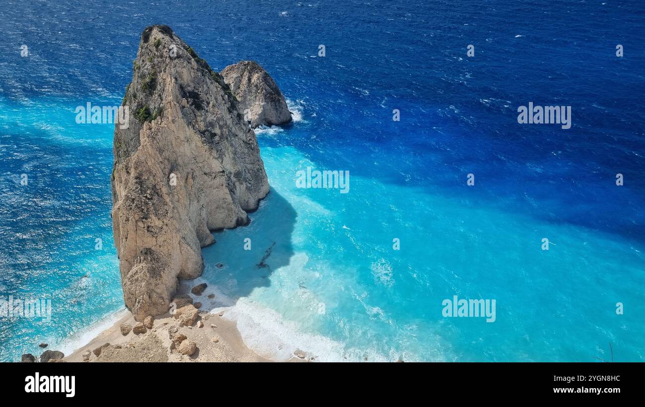 Stunning view of a huge rock on bright blue waters - Smartphone Captured Stock Image