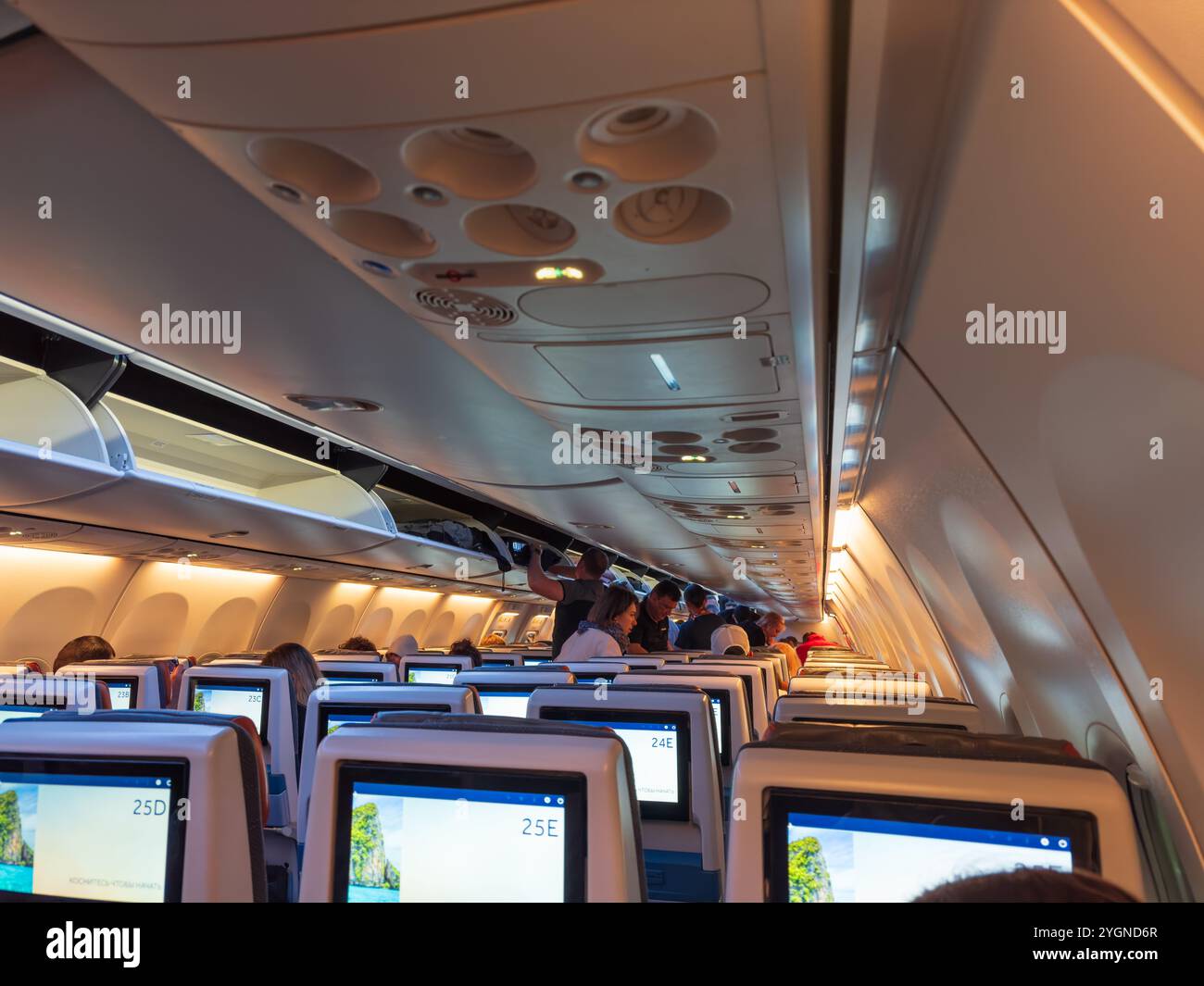 Dubai, United Arab Emirates - 3rd April, 2024 : Night time boarding and passengers settling-in on a Flydubai flight at the Dubai International Airport Stock Photo