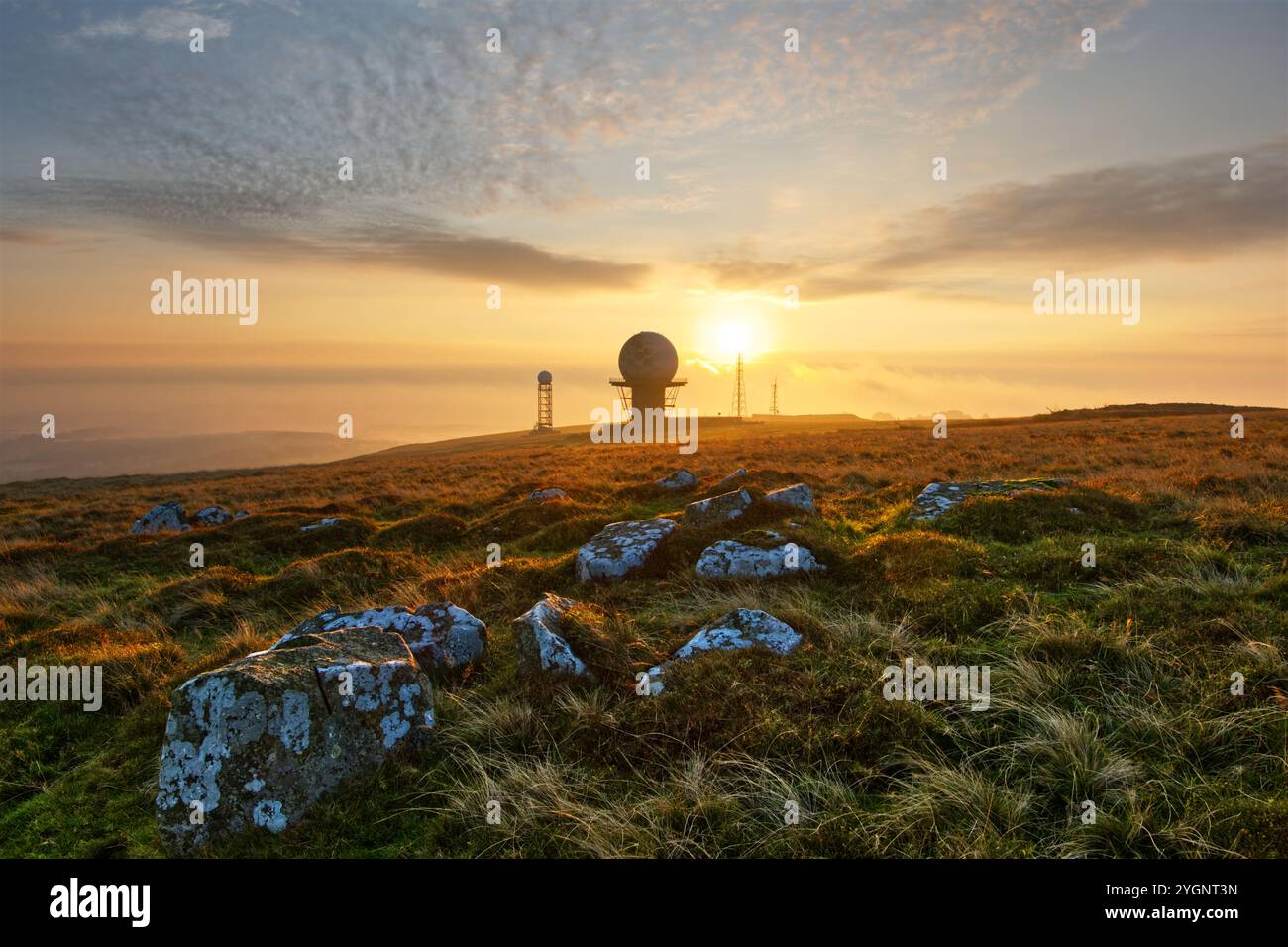 The summit of Shropshire's Titterstone Clee Hill at sunrise, showing the NATS air traffic and smaller Met Office weather radar domes Stock Photo