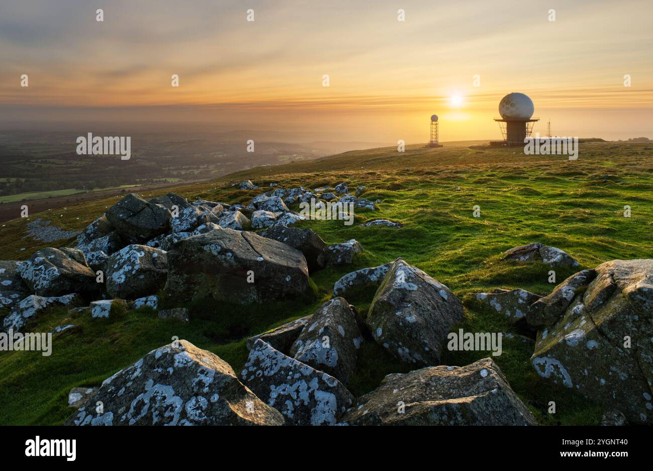 The summit of Shropshire's Titterstone Clee Hill at sunrise, showing the NATS air traffic and smaller Met Office weather radar domes Stock Photo