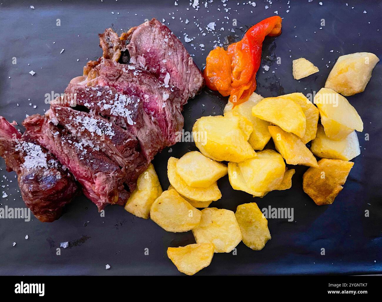 Grilled meat with fried potaoes and red pepper. - Smartphone Captured Stock Image