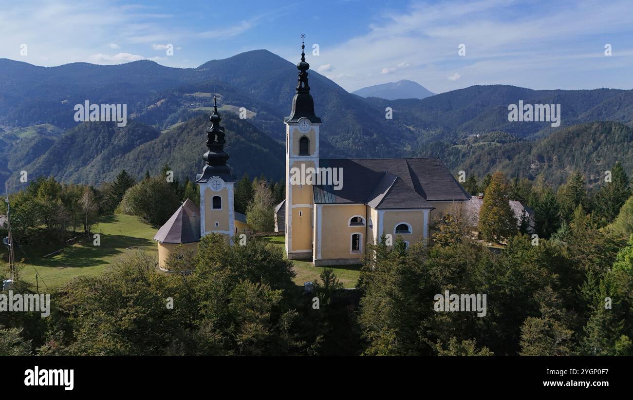 The Church of St. Cross above Šoštanj offers a stunning view of the Šalek Valley. This historic gem and popular hiking spot combines peace, beauty. Stock Photo