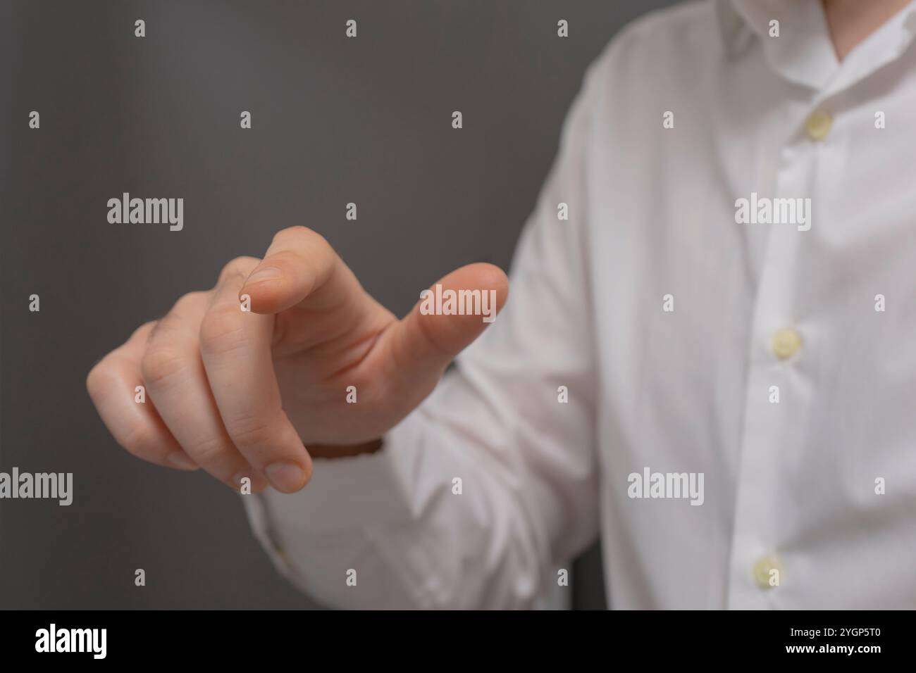 businessman hand pushing button on touch screen interface with blur background. Stock Photo