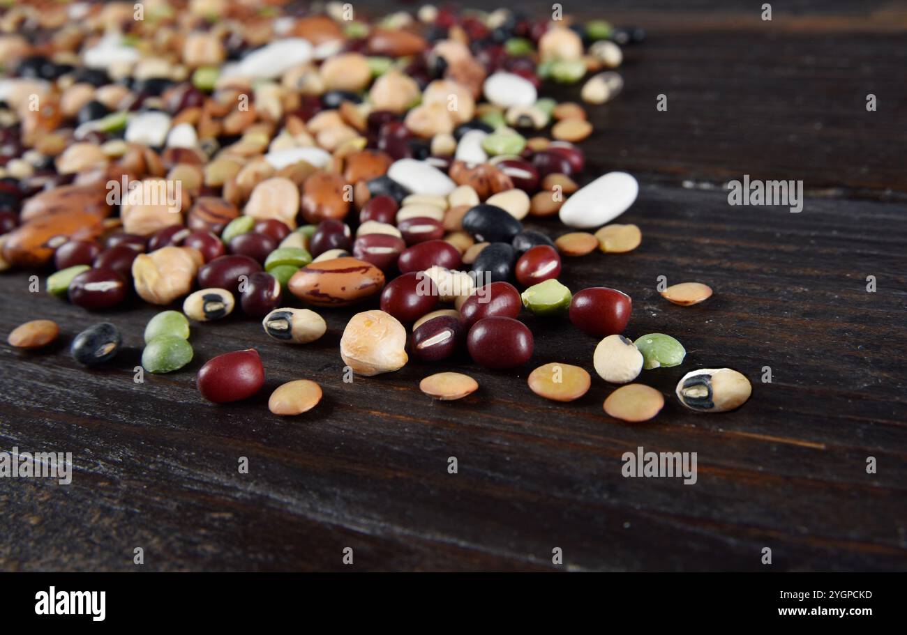 dried legumes and beans scattered on a dark background Stock Photo