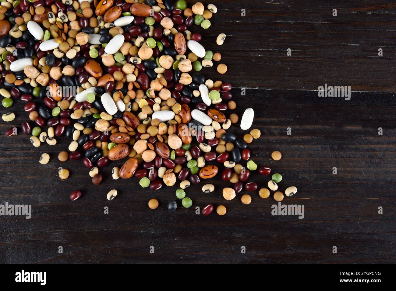 dried legumes and beans scattered on a dark background Stock Photo