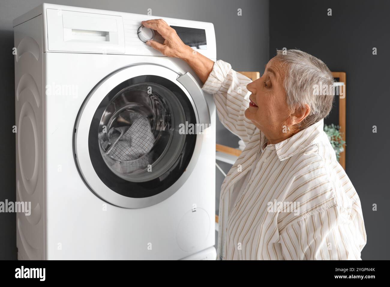Mature woman washing machine hi-res stock photography and images - Alamy