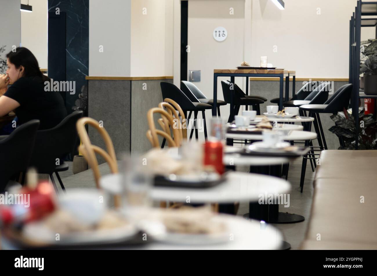 Viladecans. Spain - November 08,2024: A trendy coffee shop with empty tables after hours, highlighting the stylish interior and relaxing ambiance. The Stock Photo