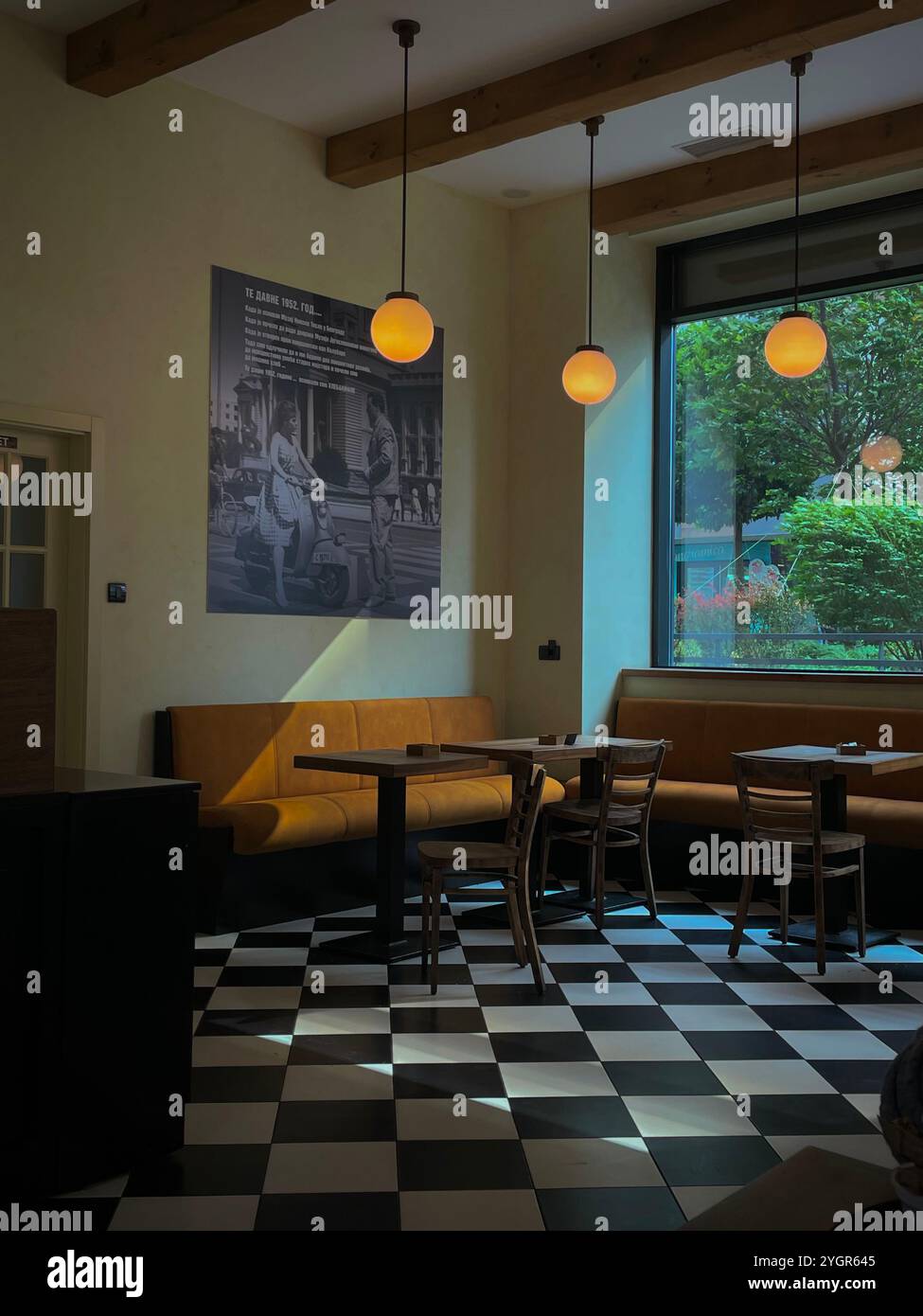 This cozy Belgrade coffee shop captures a vintage ambiance with warm tones and classic decor. - Smartphone Captured Stock Image