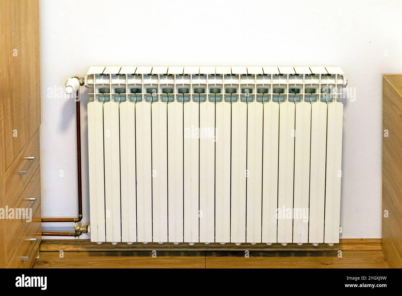 Modern heater radiator against the wall in room interior Stock Photo ...