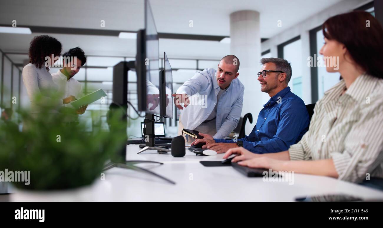 Businesspeople Analyzing Gantt Chart And Calendar On Computer In Office Stock Photo