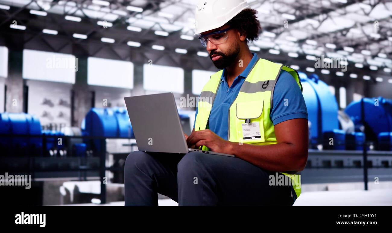 Oil And Gas Power Plant Worker Using Laptop Computer Stock Photo
