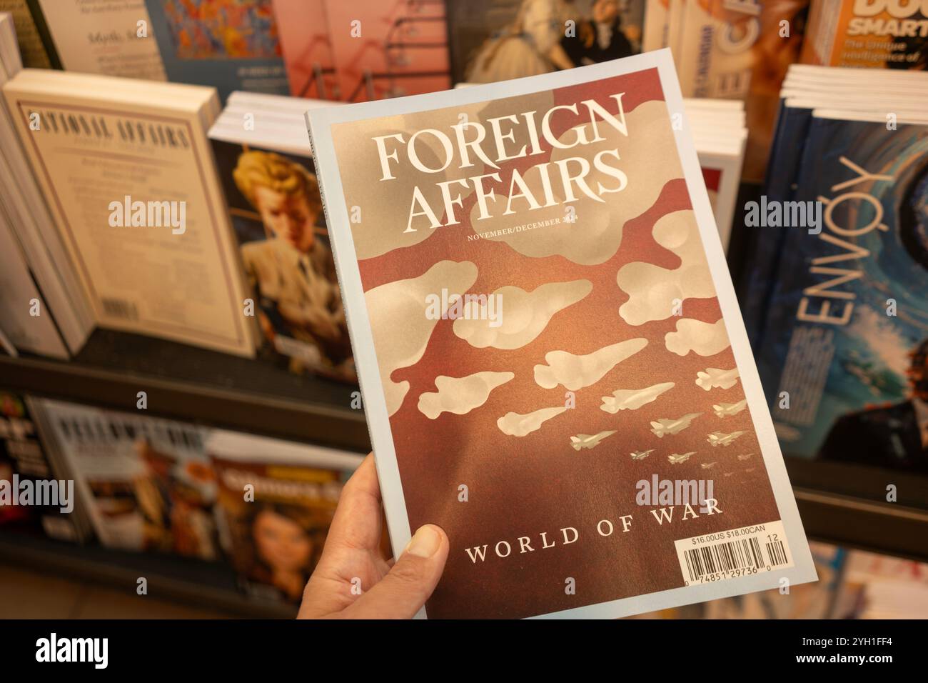 A customer picks up the latest issue of Foreign Affairs magazine from the shelf at a bookstore. Foreign Affairs is published by the Council on Foreign... Stock Photo