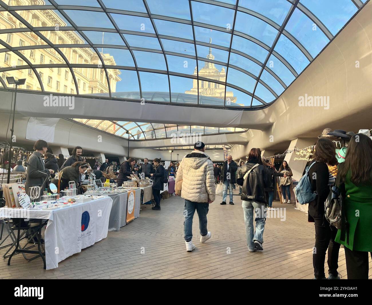 People attending an art bazaar marketplace at the Largo in Sofia Bulgaria, Eastern Europe, Balkans, EU - Smartphone Captured Stock Image