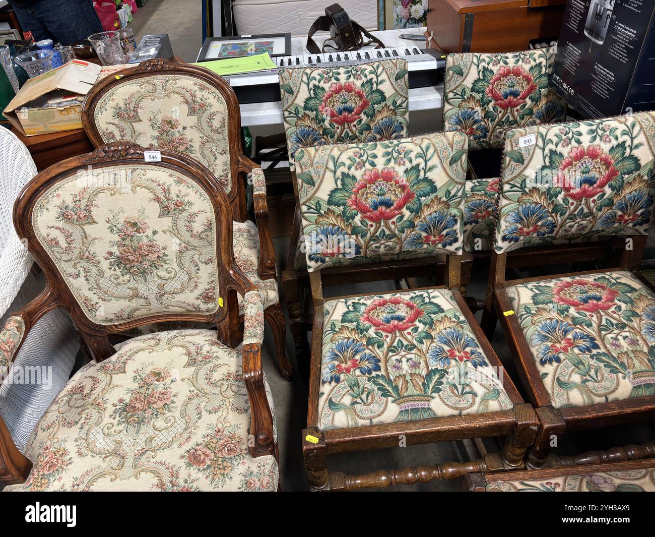 Display of embroidered antique wooden chairs, UK - Smartphone Captured Stock Image