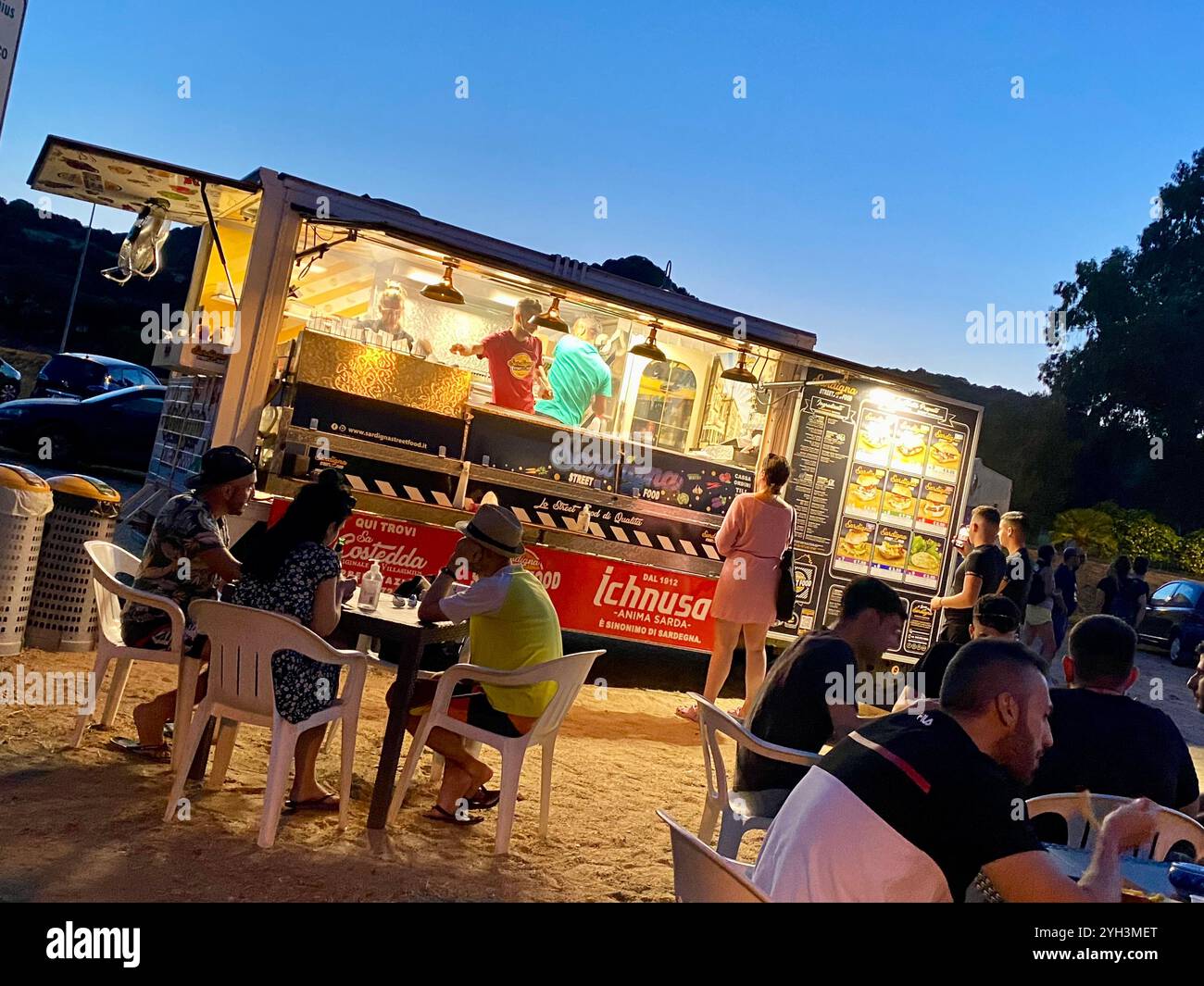 Vibrant Evening at a Busy Outdoor Street Food Truck - Smartphone Captured Stock Image