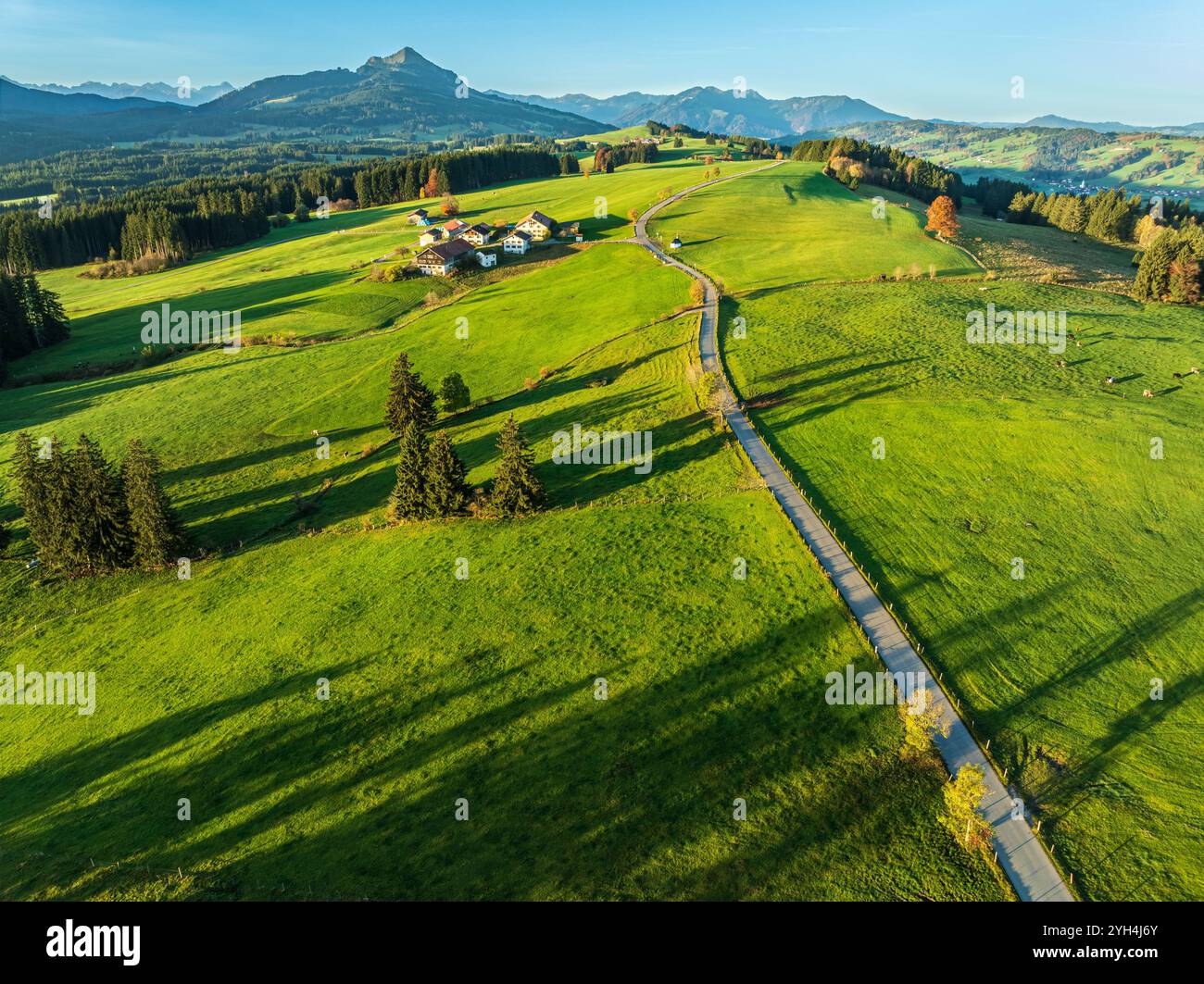 Mountain range near village Wertach, view to mt. Gruenten, sunrise,  traditional farm, aerial view,  Allgaeu, Bavaria, Germany Stock Photo