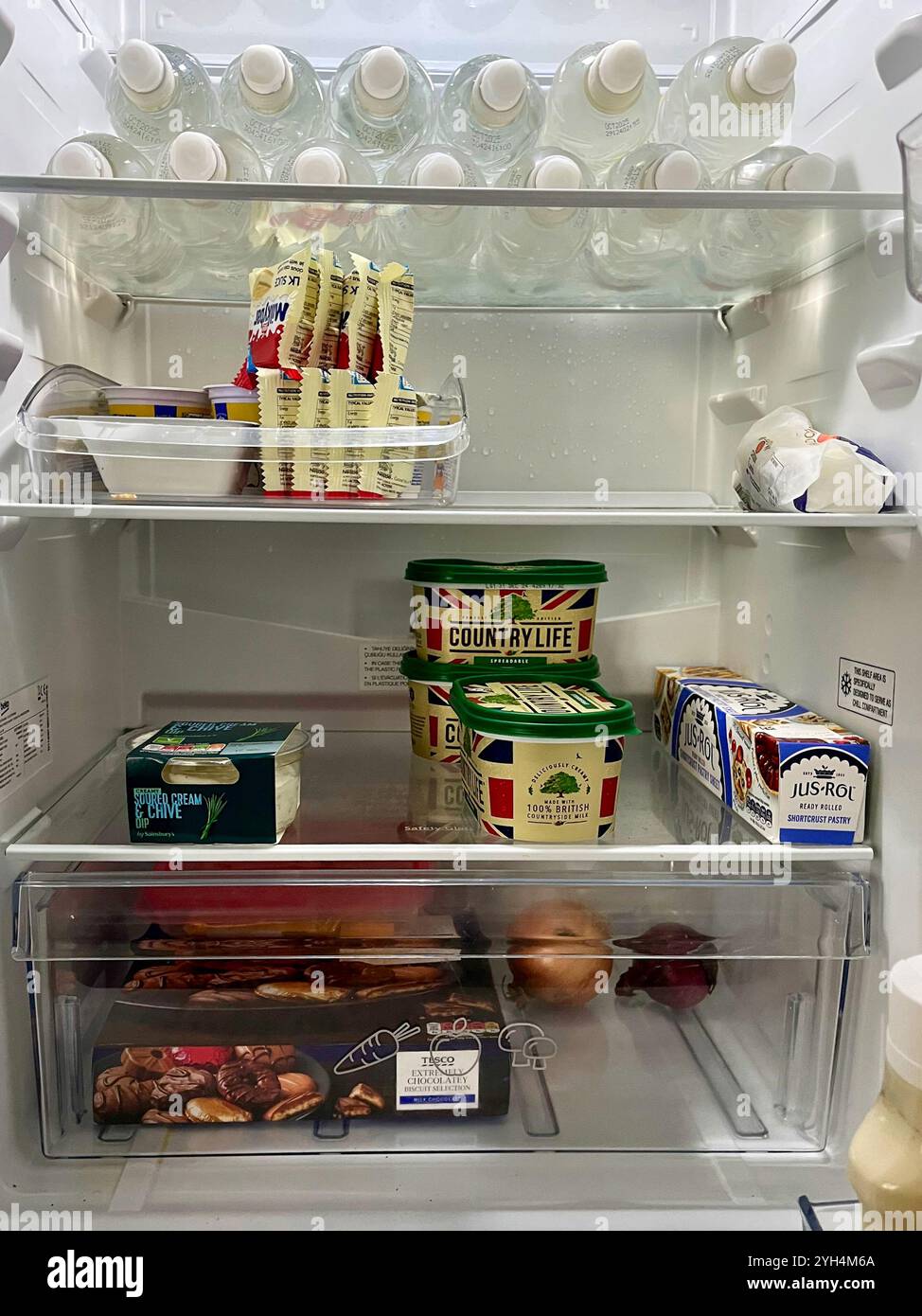 Domestic fridge stocked with foo and drinks Stock Photo