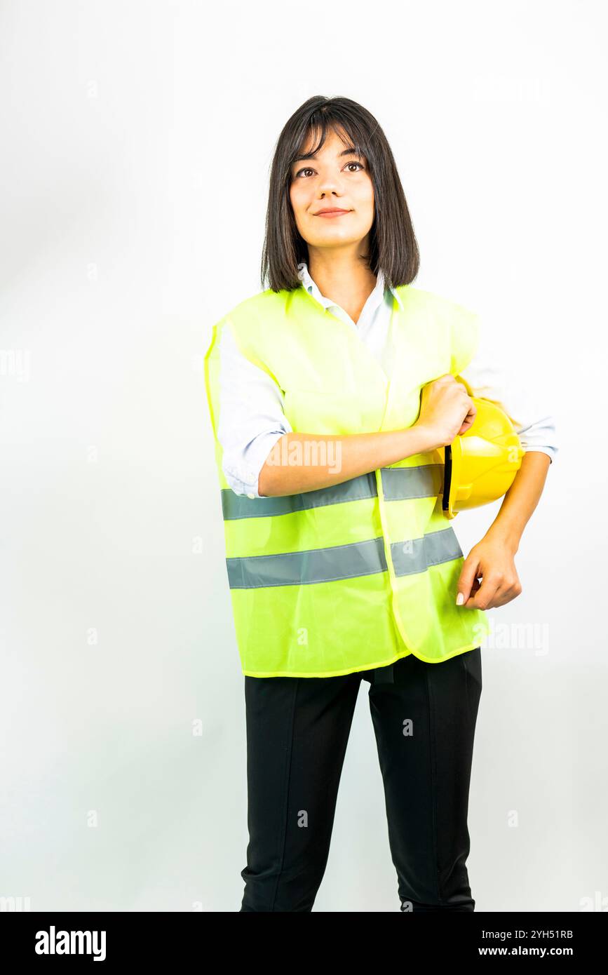 engineer woman holding a yellow hard hat Stock Photo