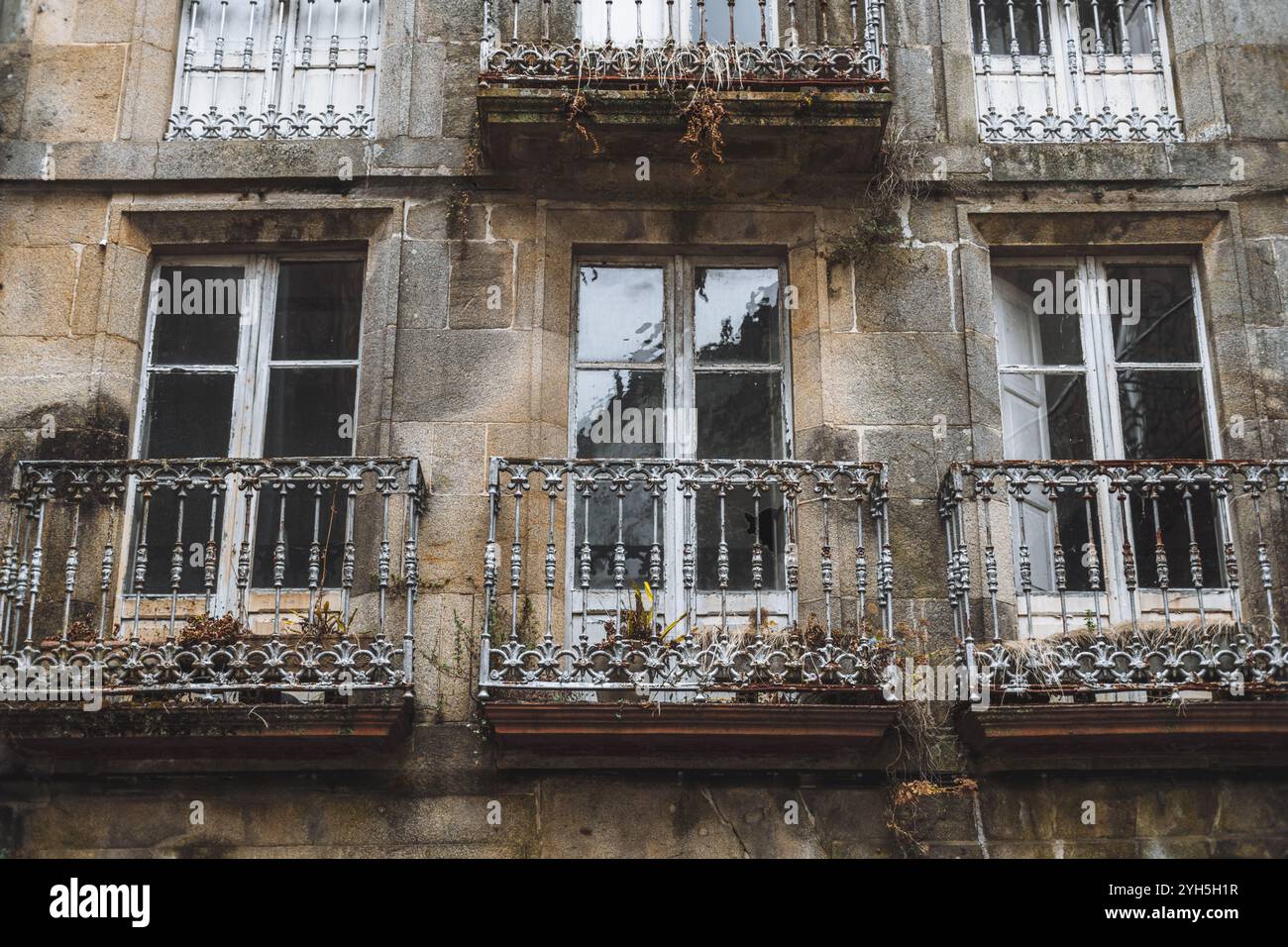 Close-up of an old European building facade with weathered stone walls ...