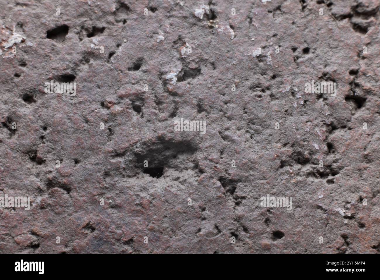 Close up of a extremely rough textured background with shadows in pink, brown, gray, black. Close up with copy space Stock Photo