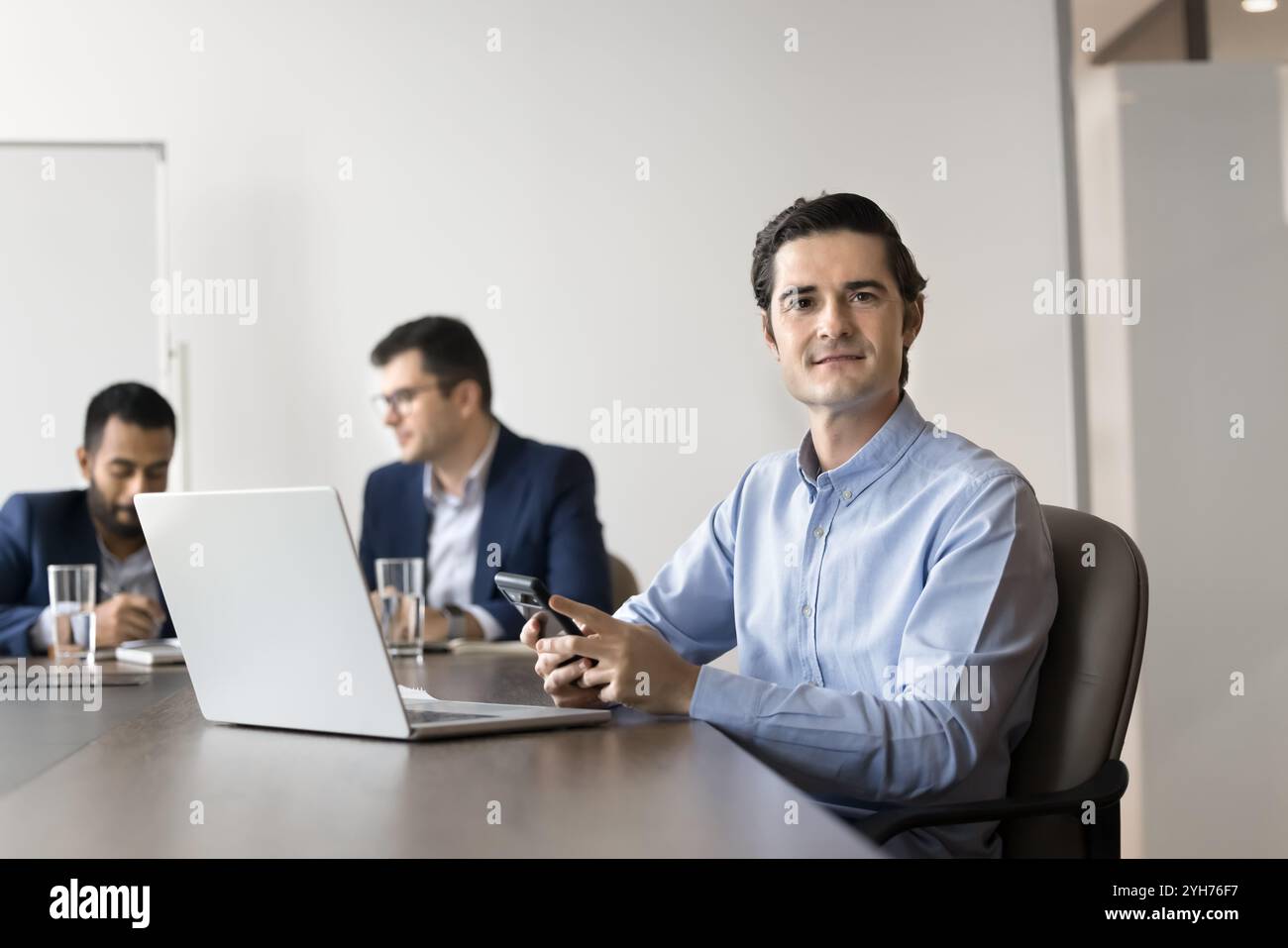 Positive confident business leader man using smartphone Stock Photo