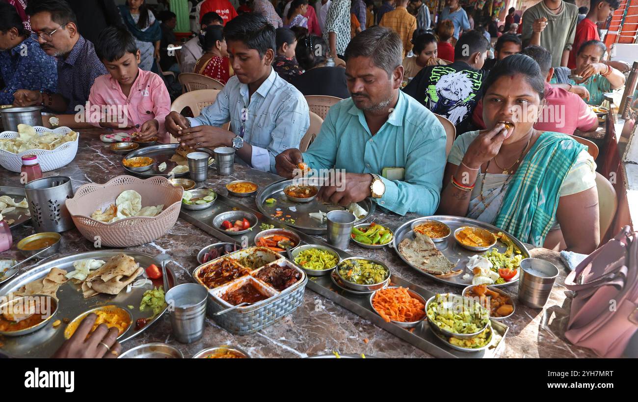 People eating thali in a food hotel in Chotila, Gujarat, India Stock Photo
