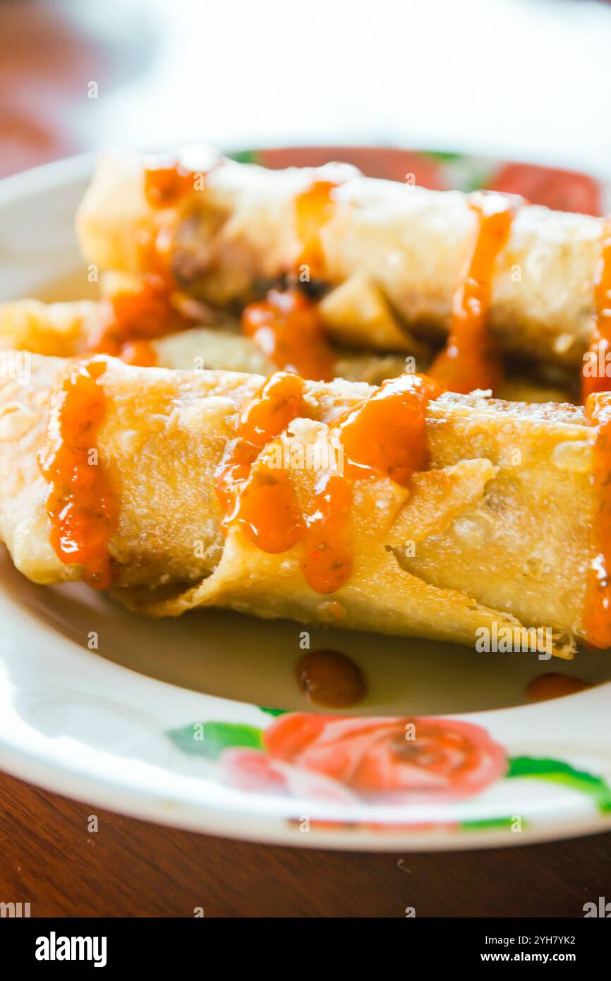 Spring rolls and sauces on wooden table, selective focus Stock Photo