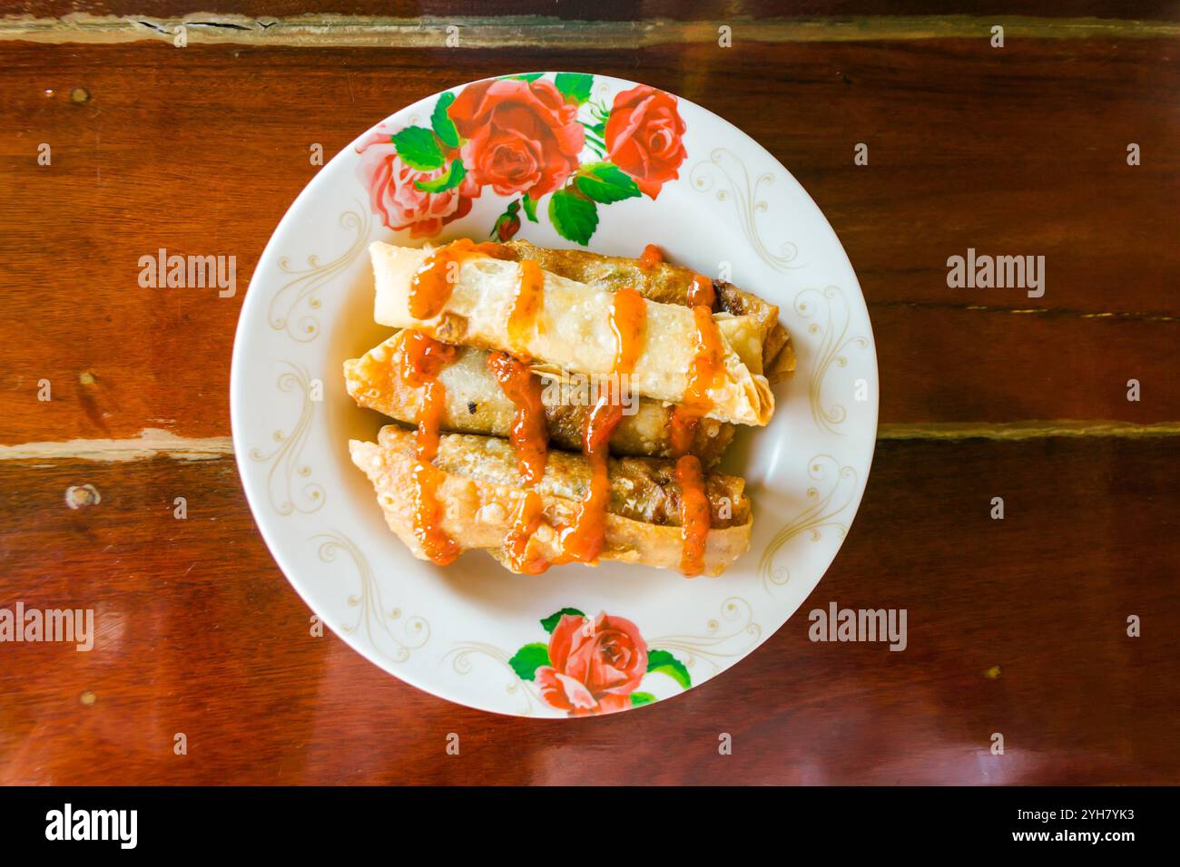 Spring rolls and sauces on wooden table, selective focus Stock Photo